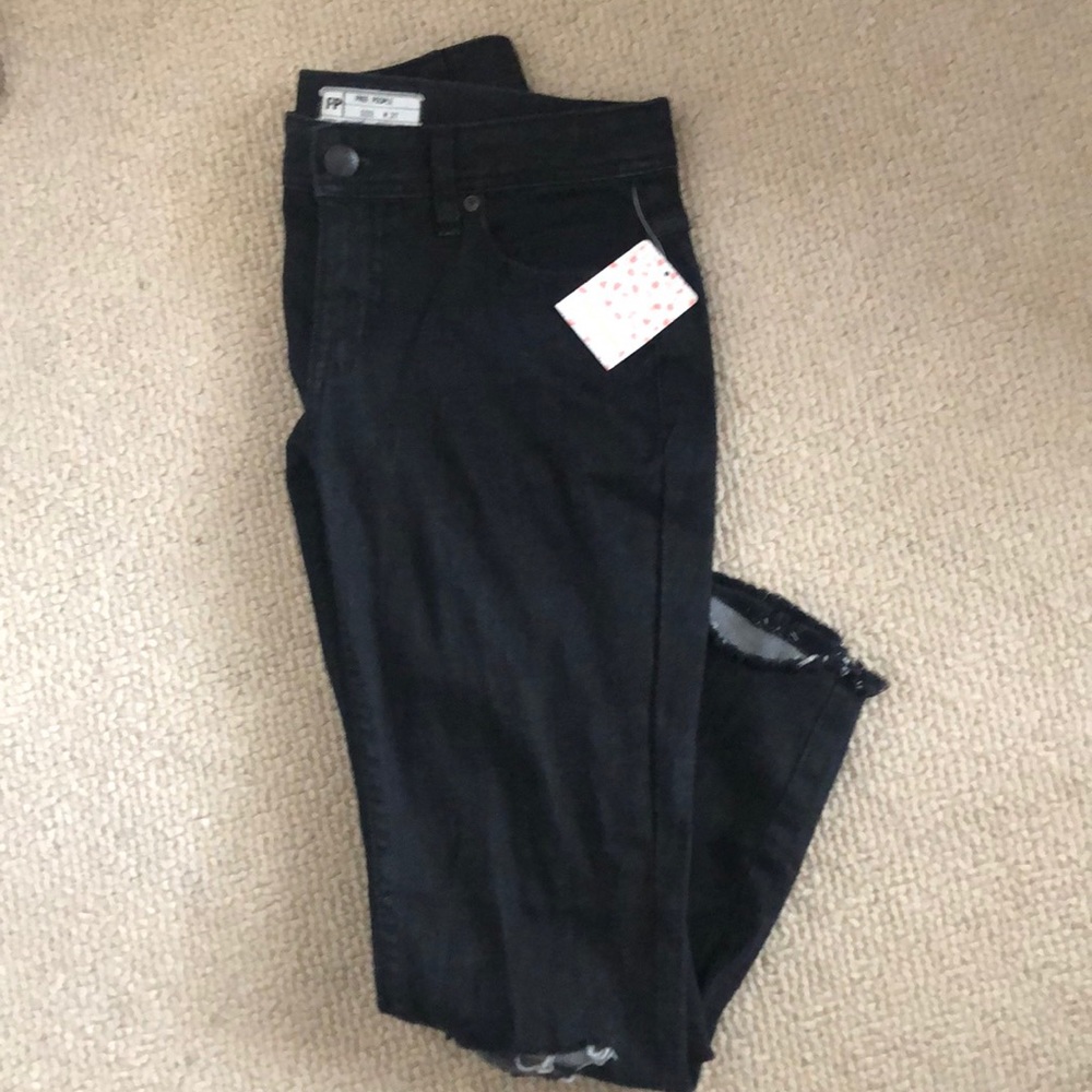 Free people skinny destroyed jeans.